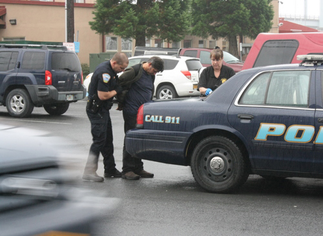 Sitka-bar-fight Richard Davis is taken into custody at the Pioneer Bar on Sunday. The 55-year-old Juneau man is skipper of the fishing vessel West Bank. He faces charges of assault and misconduct involving a weapon. (KCAW photo by Ed Ronco)