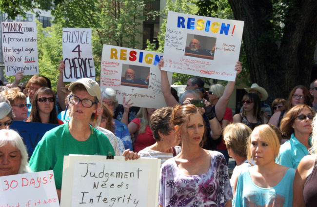 Protesters gathered outside the Yellowstone County Courthouse in Billings, Mont., on Thursday, call for the resignation of a state judge over comments he made about the teenage victim in a rape case. Matt Brown/AP Protesters gathered outside the Yellowstone County Courthouse in Billings, Mont., on Thursday, call for the resignation of a state judge over comments he made about the teenage victim in a rape case. Matt Brown/AP