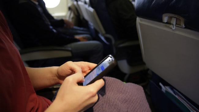 The new head of the Federal Communications Commission proposes allowing airline passengers to make phone calls during flights. Here, a passenger looks at her cellphone before a flight last month. Matt Slocum/AP The new head of the Federal Communications Commission proposes allowing airline passengers to make phone calls during flights. Here, a passenger looks at her cellphone before a flight last month. Matt Slocum/AP