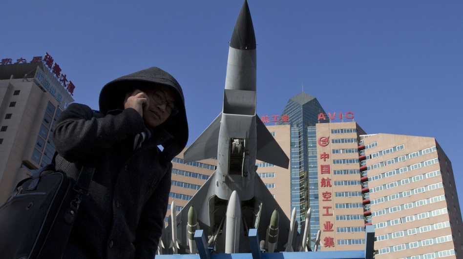 Concerns over China's air defense claims led Secretary of Defense Chuck Hagel to call Japan's defense minister Wednesday. Here, a man makes a call near a replica of a Chinese fighter jet displayed in Beijing Wednesday. Ng Han Guan/AP Concerns over China's air defense claims led Secretary of Defense Chuck Hagel to call Japan's defense minister Wednesday. Here, a man makes a call near a replica of a Chinese fighter jet displayed in Beijing Wednesday. Ng Han Guan/AP