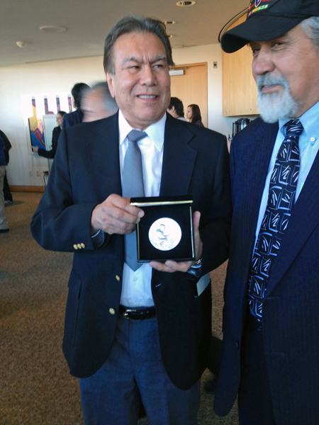 Robert-Jeff-David-Jr Robert “Jeff” David Jr., left, holds the silver medal awarded to his dad, who the family just learned was a code talker. David, of Haines, traveled to Washington, DC with former legislator Bill Thomas. Photo by Liz Ruskin, APRN – Washington DC.