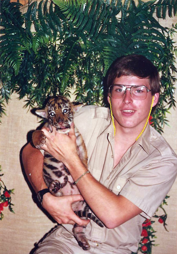 Tige and Me After Aldwyn McCuistion graduated from high school, he traveled throughout the Lower 48 for a few years. One of his favorite jobs was as a trainer for wild cats. Here he is with Tige.