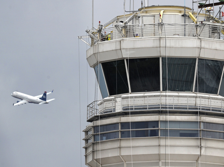 A passenger jet flies past the FAA control tower at Washington's Ronald Reagan National Airport. Cliff Owen/AP A passenger jet flies past the FAA control tower at Washington's Ronald Reagan National Airport. Cliff Owen/AP
