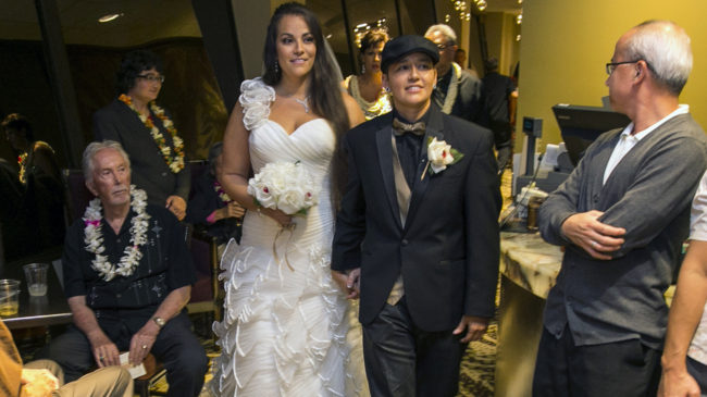 Saralyn Morales, center left, and Isajah Morales walk down the aisle at the Sheraton Waikiki in Honolulu Monday, shortly after Hawaii's new gay marriage law took effect. Marco Garcia/AP Saralyn Morales, center left, and Isajah Morales walk down the aisle at the Sheraton Waikiki in Honolulu Monday, shortly after Hawaii's new gay marriage law took effect. Marco Garcia/AP