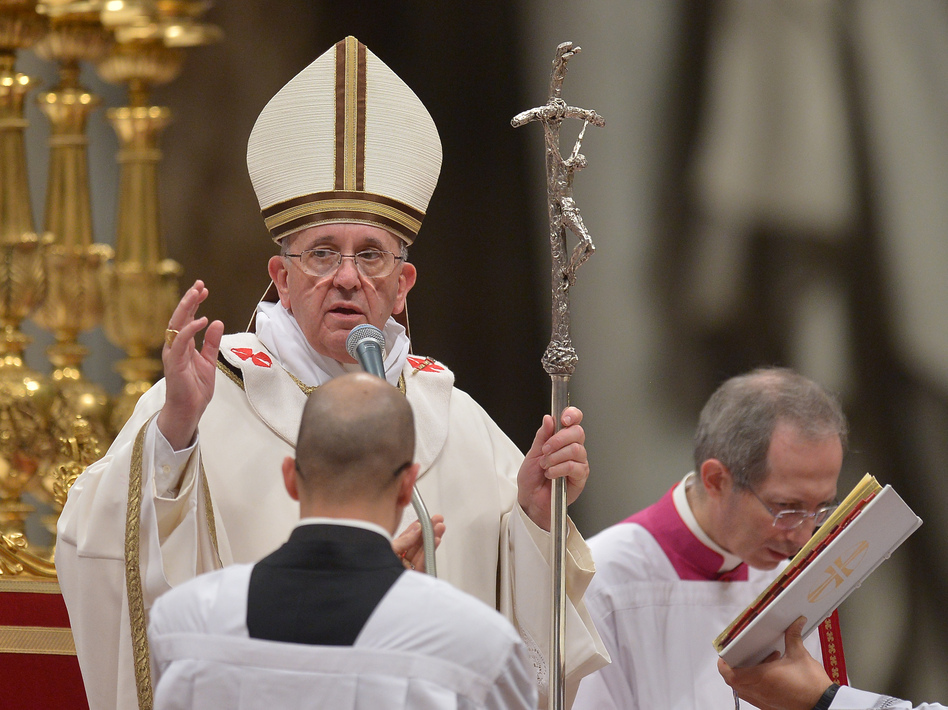 Pope Francis blesses the crowd at the Christmas Eve Mass at St. Peter's Basilica, on Tuesday at the Vatican. Filippo Monteforte/AFP/Getty Images