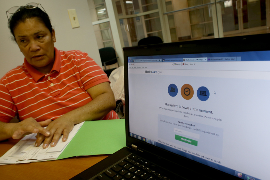 Alicia Martinez tries to sign up for a health care plan at a Miami Enrollment Assistance Center on Dec. 20, in Miami, Fla. Joe Raedle/Getty Images