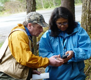 5-13 University of Alaska Southeast anthropology professor Dan Monteith goes over GPS data with Bernadine DeAsis during a dig on the UAS campus. (Ed Schoenfeld, CoastAlaska News)