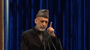 Afghan President Hamid Karzai addresses the Loya Jirga on Sunday. Karzai expressed anger at an airstrike Thursday that killed a child, saying it could imperil a security agreement with the U.S. The U.S.-led international force apologized on Friday for the killing. Massoud Hossaini/AFP/Getty Images Afghan President Hamid Karzai addresses the Loya Jirga on Sunday. Karzai expressed anger at an airstrike Thursday that killed a child, saying it could imperil a security agreement with the U.S. The U.S.-led international force apologized on Friday for the killing. Massoud Hossaini/AFP/Getty Images
