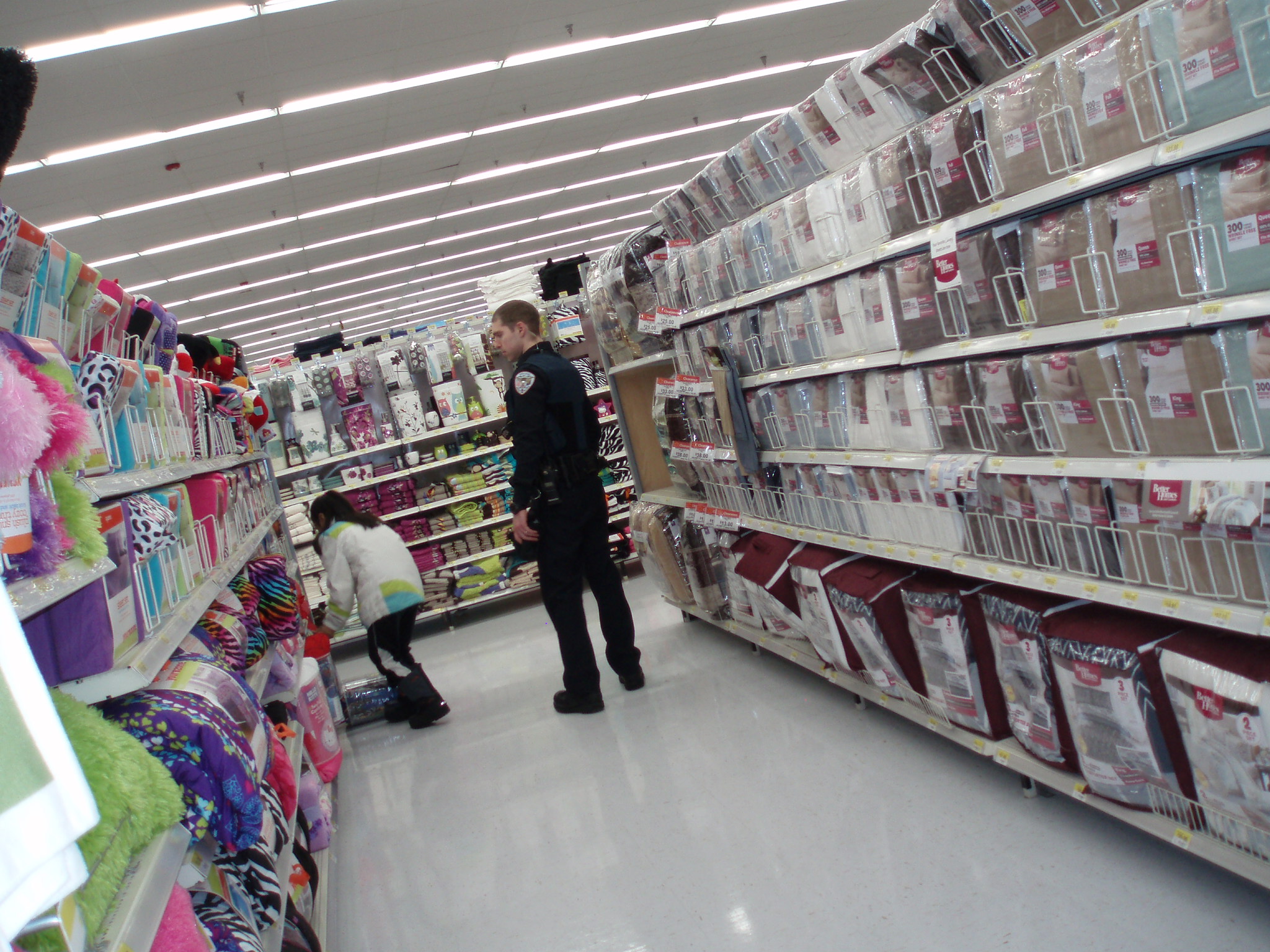 Juneau Police Officer James Dooley peruses the aisles of Wal-Mart with a child during Shop with a Cop. (Photo courtesy of Sarah Hieb)