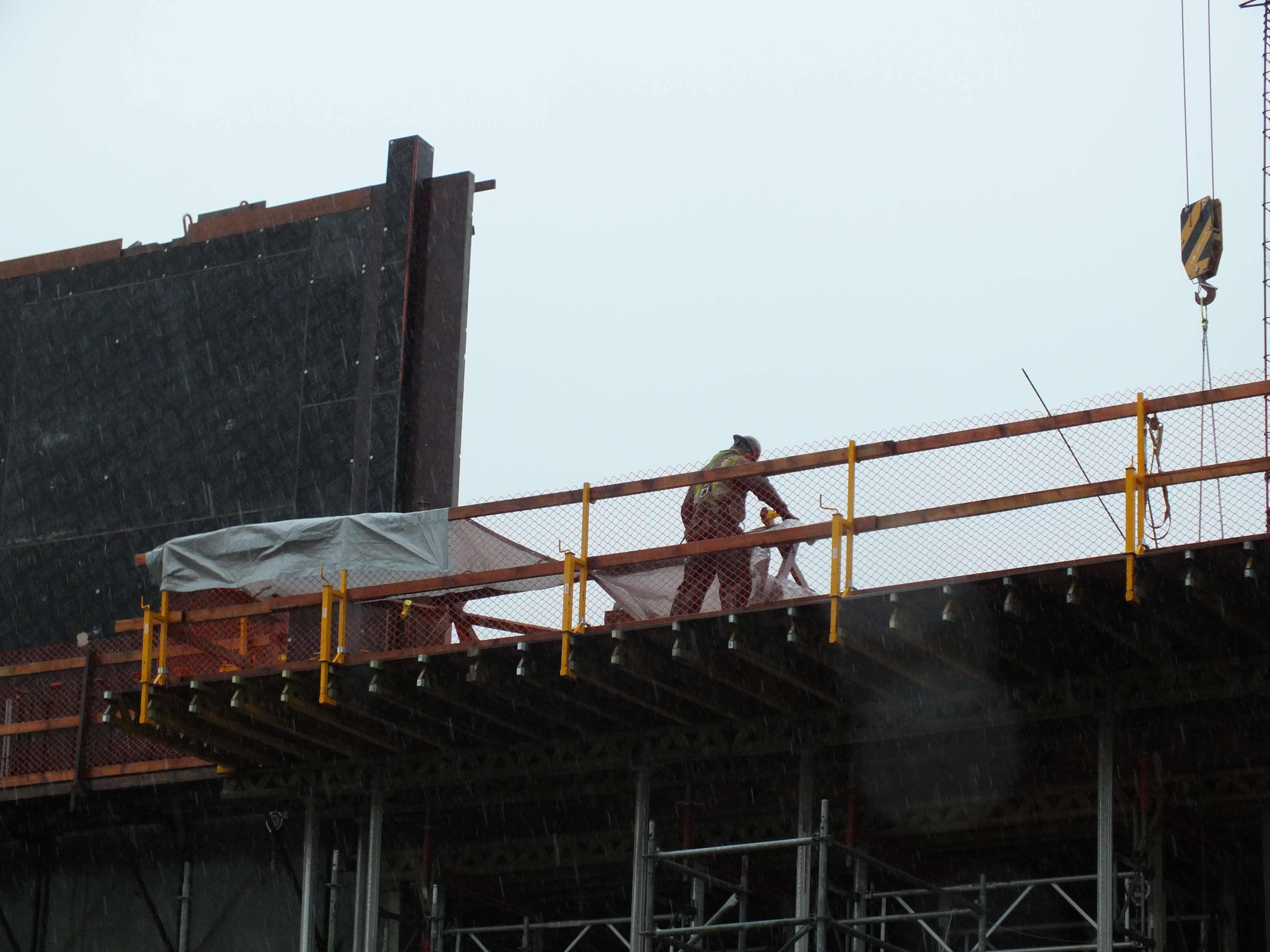 A construction worker at the current top of the State Libraries, Archives, and Museum (SLAM) project. (Photo by Matt Miller/KTOO)