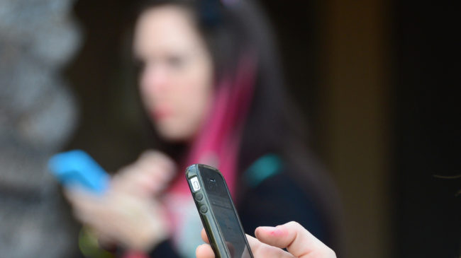 The U.S. Supreme Court has agreed to decide if police can seize and look through a suspect's cellphone without getting a warrant. This photo shows women in Los Angeles using smartphones on Jan. 7. Frederic J. Brown/AFP/Getty Images