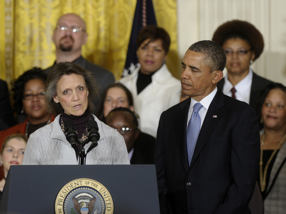 President Obama listens as Katherine Hackett of Moodus, Conn., speaks during an event in the East Room of the White House in Washington, on Tuesday. Susan Walsh/AP