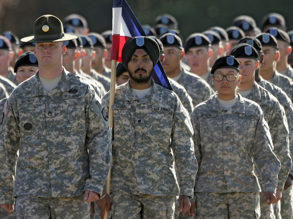 U.S. Army Spc. Simran Lamba, center, was granted a religious accommodation for his Sikh articles of faith, including uncut hair and a turban, in 2010. He was the first enlisted soldier to be given such an accommodation since 1984. Brett Flashnick/AP