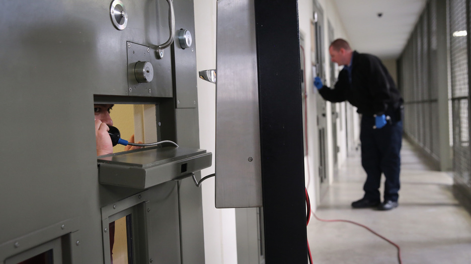 The U.S. holds more prisoners in solitary confinement than any other democratic country, according to critics of the treatment. Here, an immigrant detainee makes a call from his "segregation cell" at a detention facility in Adelanto, Calif., last November. John Moore/Getty Images