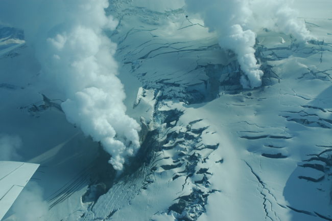 Views of Fourpeaked volcano and area of volcanic activity on the north flank in 2006. (Photo by Christina Neal. Courtesy of Alaska Volcano Observatory / U.S. Geological Survey)