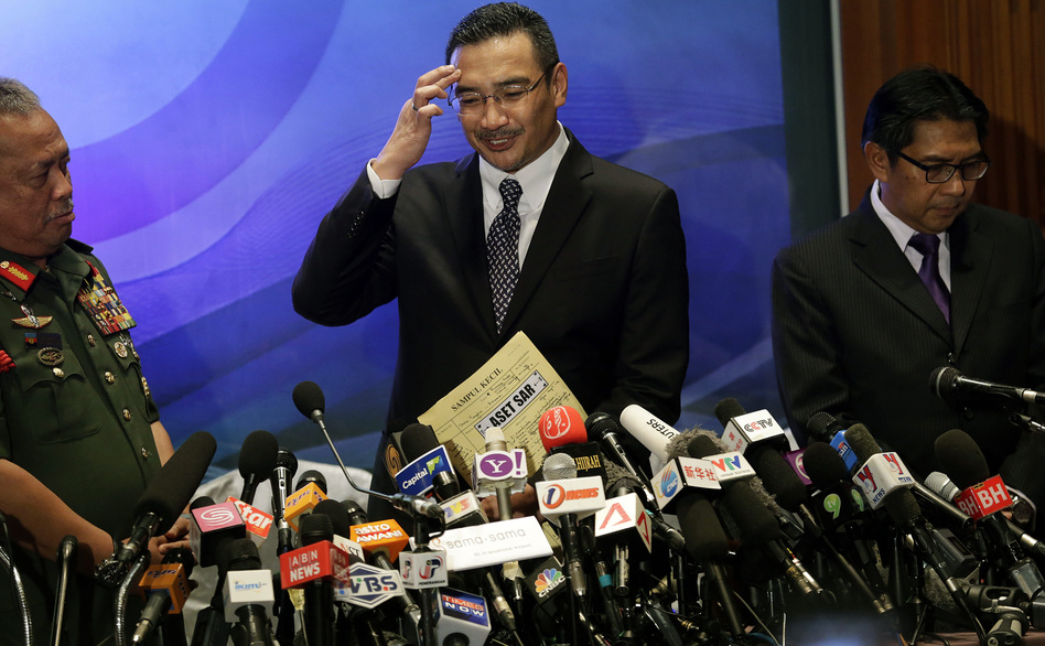 Scratching their heads: Malaysia's minister of transport, Hishamuddin Hussein (center), tried to answer reporters' questions Wednesday about the disappearance of Malaysia Airlines Flight 370. He was joined by Azharuddin Abdul Rahman, director general of the Malaysian Department of Civil Aviation, and Gen. Zulkifeli Mohd Zin. Wong Maye-E/AP