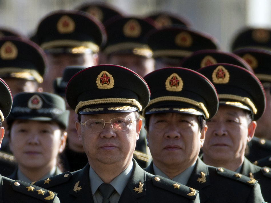 Delegates from China's People's Liberation Army (PLA) march from Tiananmen Square to the Great Hall of the People to attend sessions of National People's Congress and Chinese People's Political Consultative Conference Tuesday in Beijing. Ng Han Guan/AP