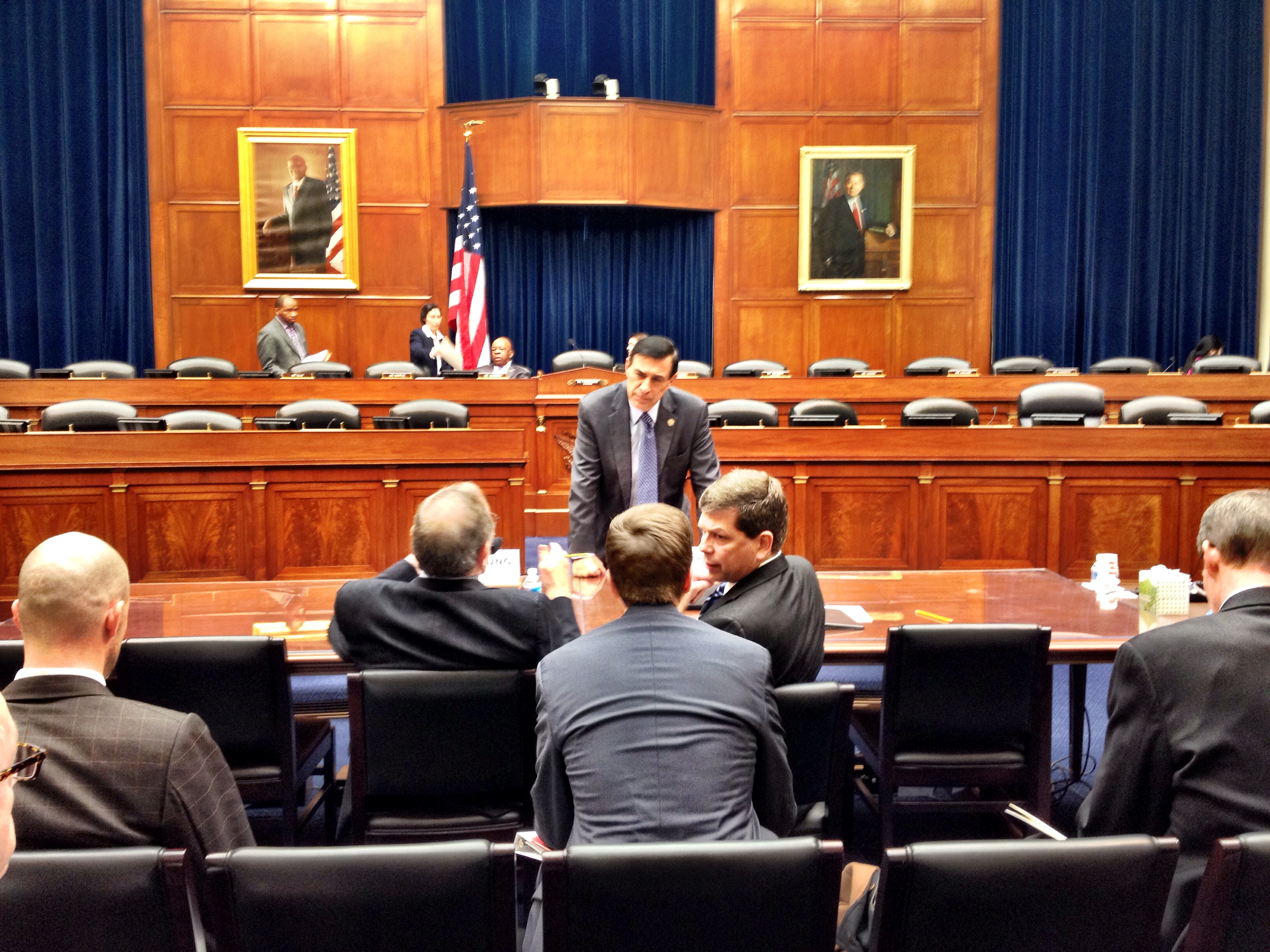 Rep. Darrell Issa, standing, chats with Alaska Congressman Don Young and Sen. Mark Begich before the hearing. (Photo by Liz Ruskin)