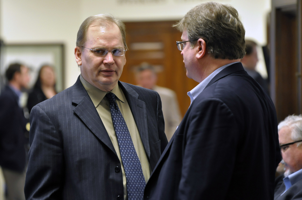 Rep. Mark Neuman pauses for a conversation in the second floor hallway of the Capitol building, Feb. 24, 2014. (Photo by Skip Gray/Gavel Alaska)
