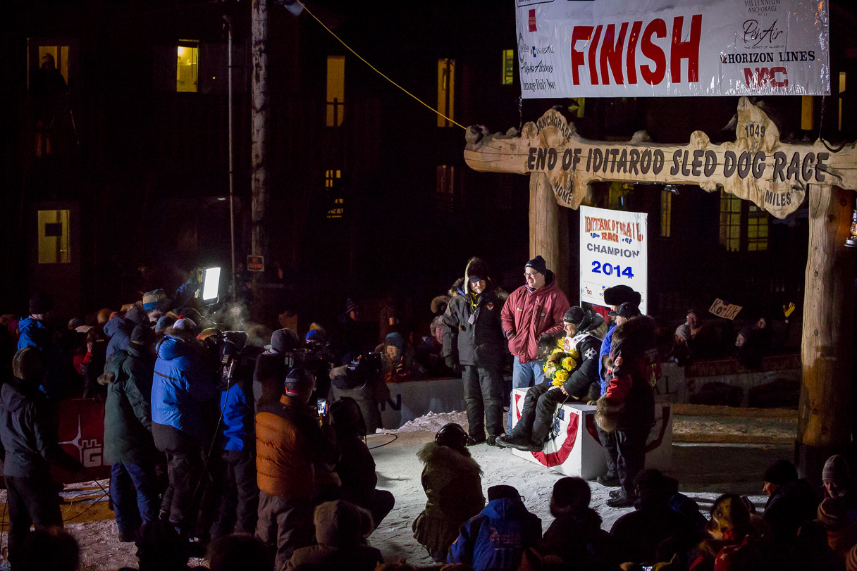 2014 Iditarod champion Dallas Seavey celebrates his victory in Nome. (Photo by David Dodman, KNOM Radio Mission)