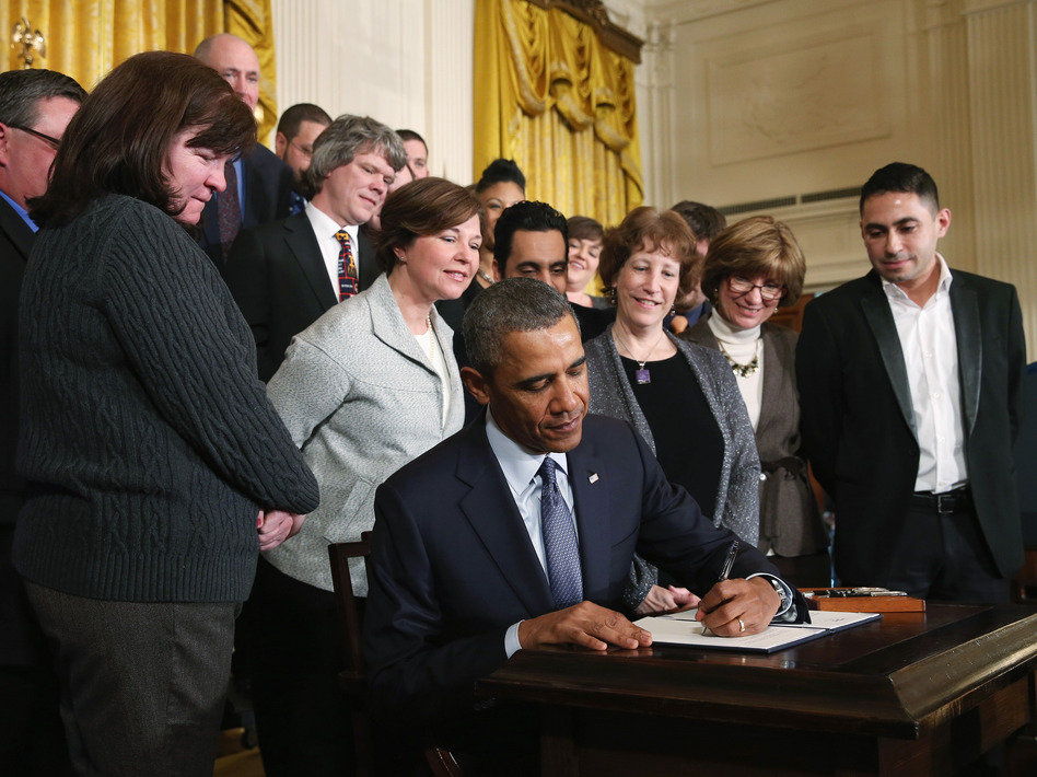 President Obama signs a memorandum for overtime protections for workers, at the White House on Thursday. Mark Wilson/Getty Images