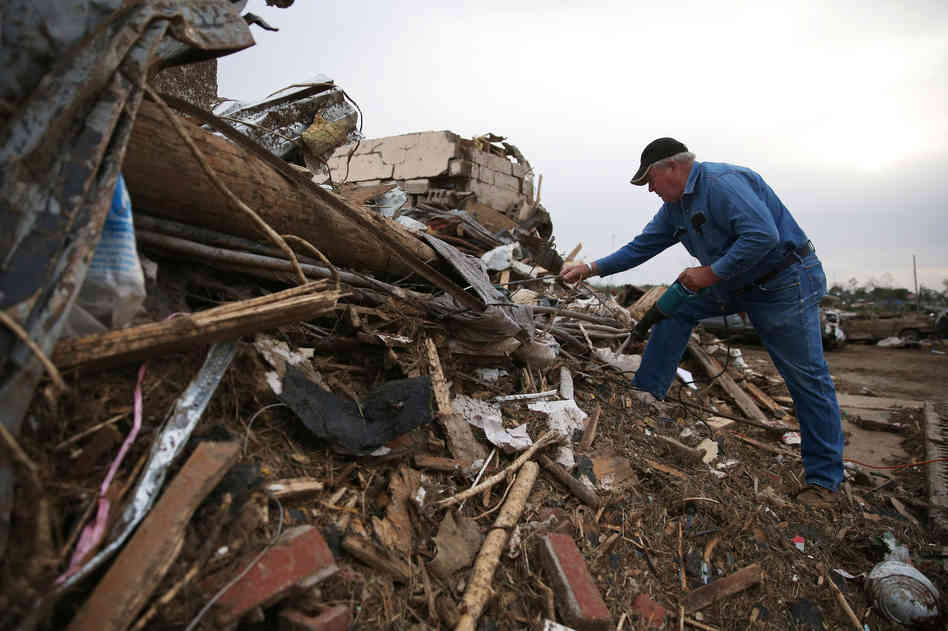 John Folked cuts downed power lines where his realty business was destroyed by a tornado two days earlier, in Vilonia, Ark. A second day of tornadoes has caused devastation in the South, killing more than a dozen people in Mississippi, Alabama and Tennessee. The storms came a day after tornadoes swept through Arkansas, Oklahoma and Iowa on Sunday and Monday, killing at least 17 people. Mark Wilson/Getty Images
