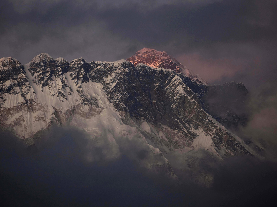 The sun shines on the peak of Mount Everest in this October 2011 photo. On Friday, an avalanche killed at least 12 Sherpas on the mountain. Kevin Frayer/AP
