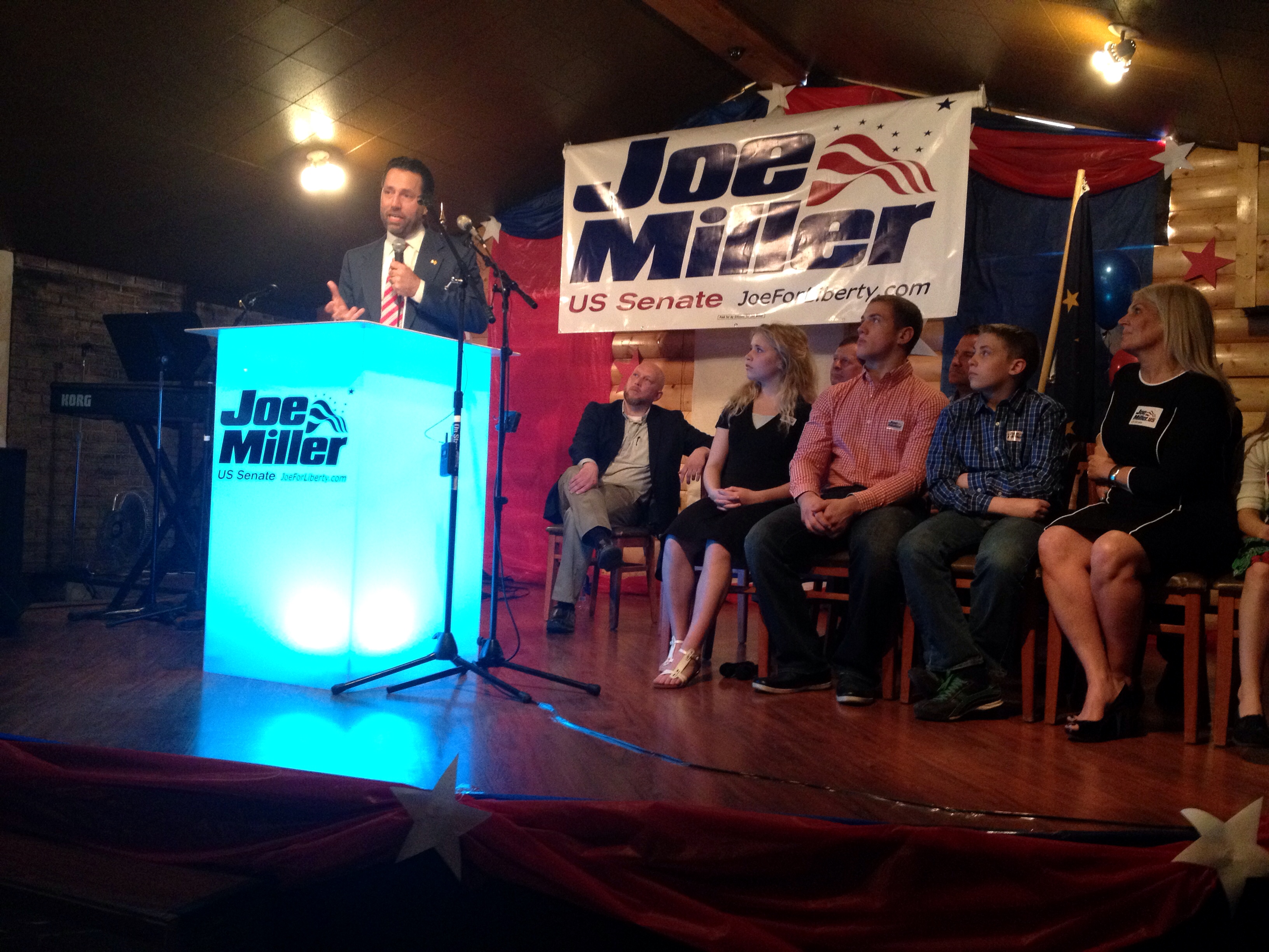 Joe Miller, with family in front row on stage. (Photo by Liz Ruskin/APRN)