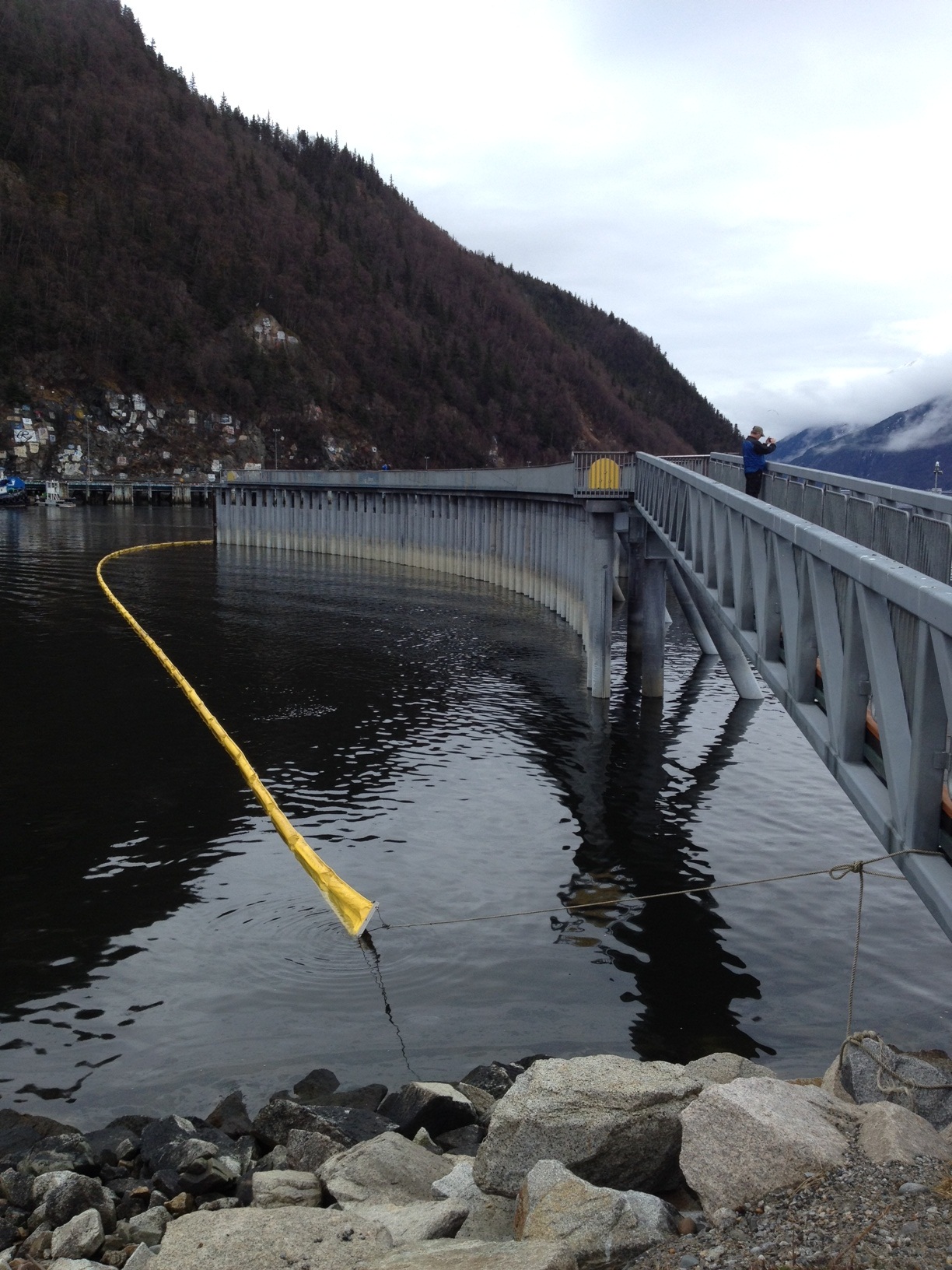 Absorbent boom has been deployed around the dock area. (Photo by Doug Smith/KHNS)