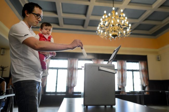 A man casts his ballot on Sunday in Bulle, western Switzerland, during a referendum. Fabrice Coffrini /AFP/Getty Images