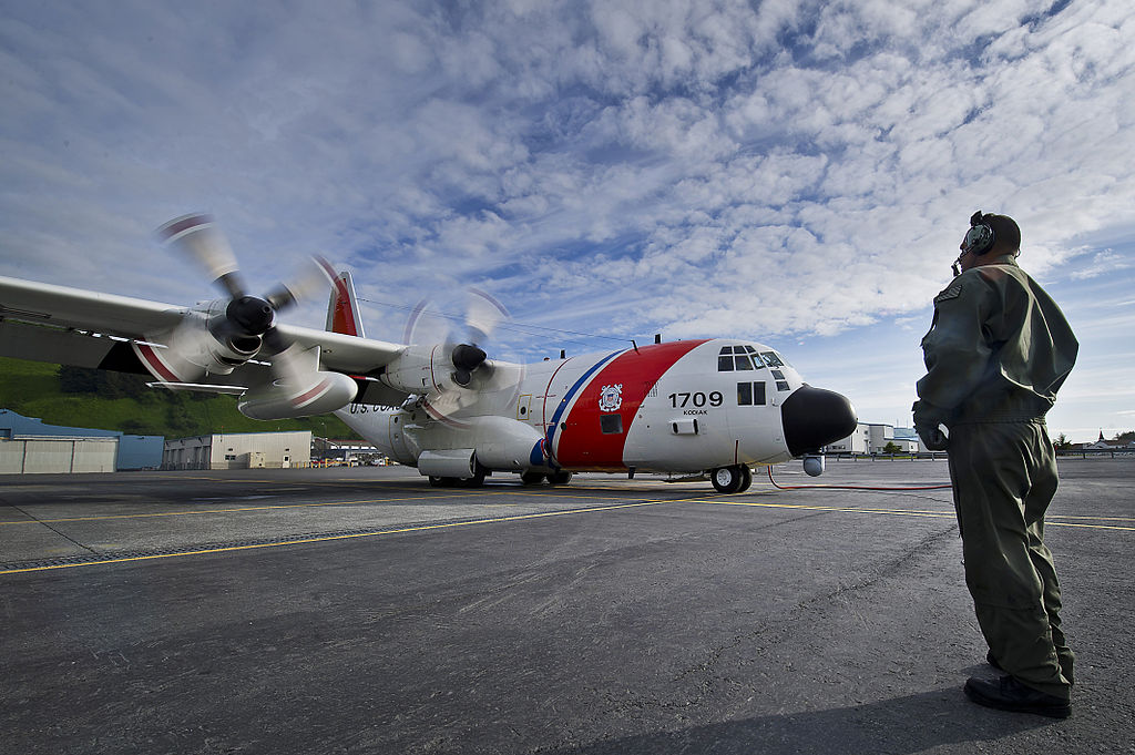 U.S. Coast Guard Petty Officer 2nd Class Shane Ramos, an aviation maintenance technician loadmaster, communicates with pilots before launching an HC-130H Hercules aircraft in Barrow, Alaska, June 28, 2012. Coast Guardsmen from Air Station Kodiak flew daily missions to Barrow in preparation for a Coast Guard deployment to Arctic Shield, a temporary air station operating in the Arctic Ocean during the summer to increase search and rescue response times in the region.