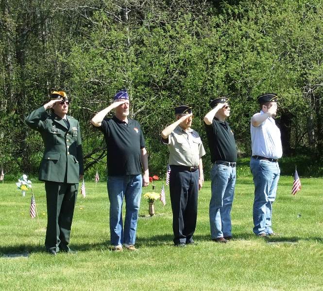 Veterans salute the flag at the 2013 Memorial Day observance at Alaskan Memorial Park. (Photo by Rosemarie Alexander/KTOO)