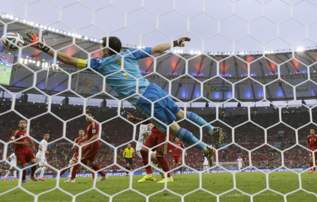 Spain's goalkeeper, Iker Casillas, fails to save an attempt by Chile's Charles Aranguiz at the Maracana Stadium in Rio de Janeiro on Wednesday. Manu Fernandez/AP