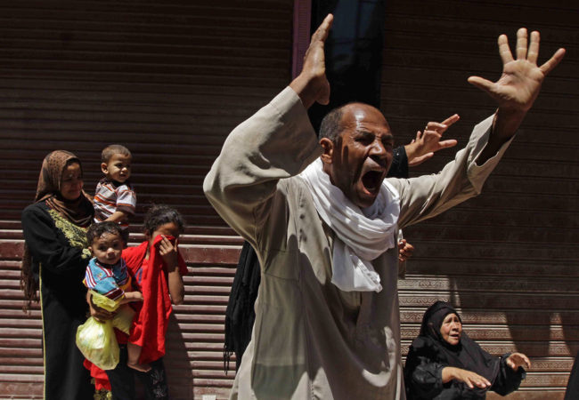 Relatives of a Muslim Brotherhood member who was sentenced to death react to the verdict outside a courtroom in Minya, Egypt, on Saturday. Ravy Shaker/AP
