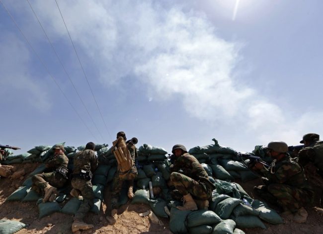 Iraqi Kurdish forces take position near Taza Khormato as they fight jihadist militants from the Islamic State of Iraq and Syria (ISIS) positioned five kilometers away in Bashir on Monday. Karim Sahib /AFP/Getty Images