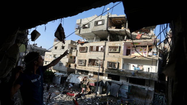 Palestinians inspect the rubble of a house hit by an Israeli missile strike in Gaza City on Thursday. Israel escalated its aerial assaults on Gaza on Thursday, with Prime Minister Benjamin Netanyahu saying there are no plans for a cease-fire. Hatem Moussa/AP