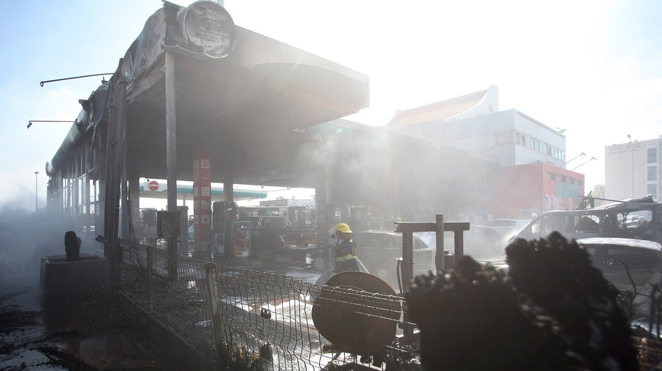 Israeli firefighters extinguish vehicles at a gas station in Ashdod, Israel, that was hit by a rocket fired from the Gaza Strip on Friday. David Buimovitch/AFP/Getty Images