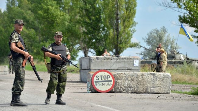 Ukrainian soldiers man a checkpoint about 30 miles from Donetsk on Thursday. A government official said Friday that a rocket attack had killed as many as 30 troops. Genya Savilov/AFP/Getty Images