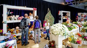 Visitors look at a memorial at Amsterdam's Schiphol Airport on Monday. ROBIN VAN LONKHUIJSEN/AFP/Getty Images