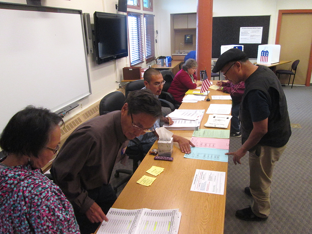 Voters at the Lower Kuskokwim School District choosing primary election ballots on Tuesday, August 19th, 2014. Some voters had to ask for assistance understanding the ballot translation.(Photo by Daysha Eaton/KYUK)