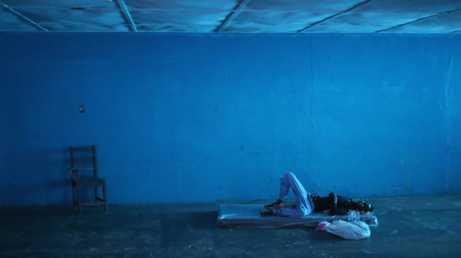 A man lies in a newly opened Ebola isolation center in a closed school in Monrovia, Liberia on Thursday. The official death toll of 1,000 people in four countries is likely below the actual number, the World Health Organization says. John Moore/Getty Images