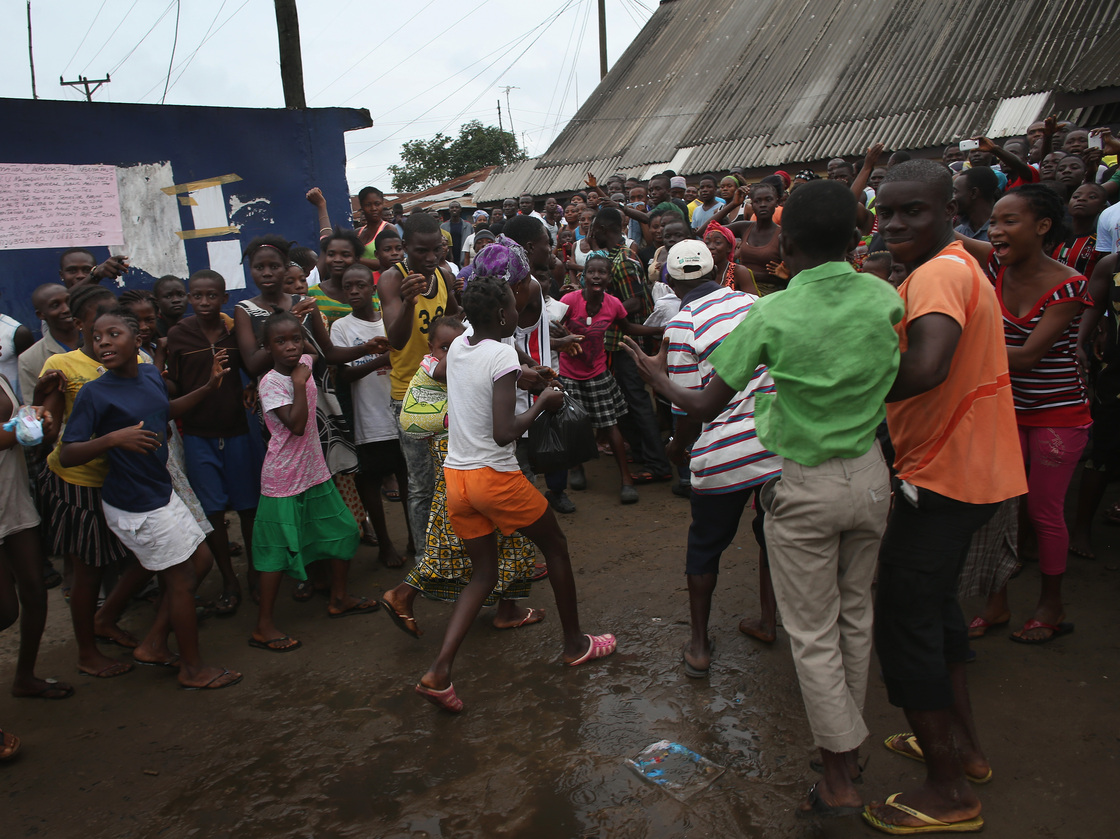 A family (center) leaves an Ebola isolation center after a mob forced open the gates of the facility in the West Point slum on Saturday in Monrovia, Liberia. John Moore/Getty Images