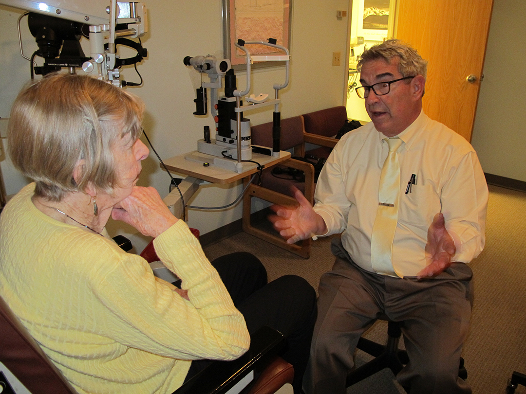 Dr. Koshin talks with a patient at his office. Many of his patients have aged into Medicare along with him. (Photo by Annie Feidt/APRN)