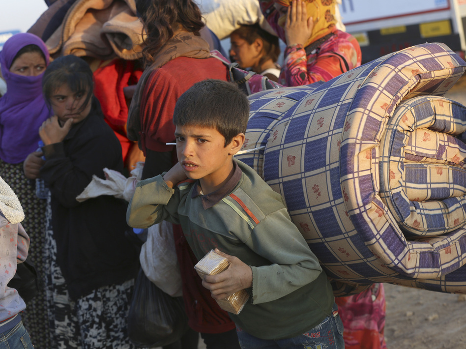 Thousands of Syrians enter Turkey at Yumurtalik crossing gate near Suruc on Tuesday. The United Nations High Commissioner for Refugees has warned of a growing refugee crisis. Burhan Ozbilici/AP