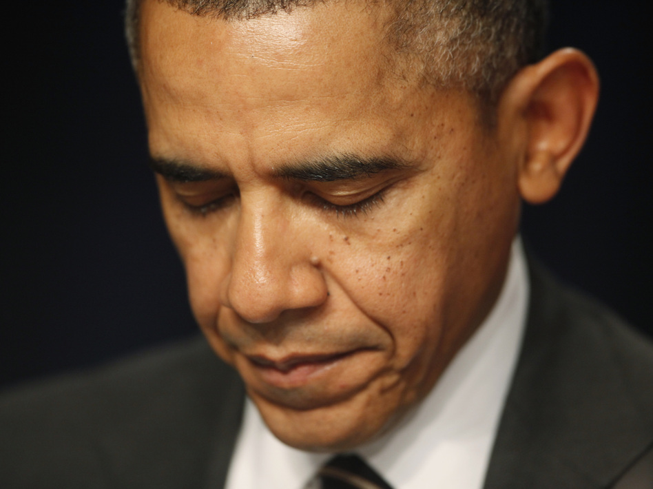President Obama closes his eyes as a prayer is offered at the National Prayer Breakfast in February in Washington, D.C. Charles Dharapak/AP