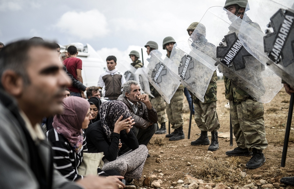 Turkish military forces of the Jandarma (police) block access at the Mursitpinar crossing gate near the Syrian border, where Syrian Kurdish people seek to pass, on Sunday. Turkey's leader says the country is willing to fight ISIS. Bulent Kilic/AFP/Getty Images