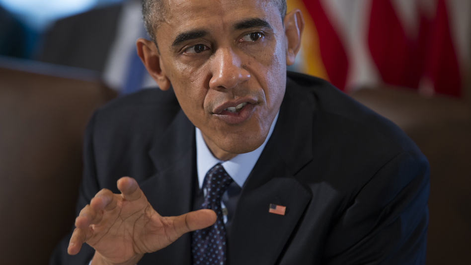 President Obama speaks to the media before meeting with his Cabinet in the White House Friday. The president is ordering up to 1,500 additional military personnel to Iraq, to help Iraqi and Kurdish forces fight the extremist group ISIS. Evan Vucci/AP