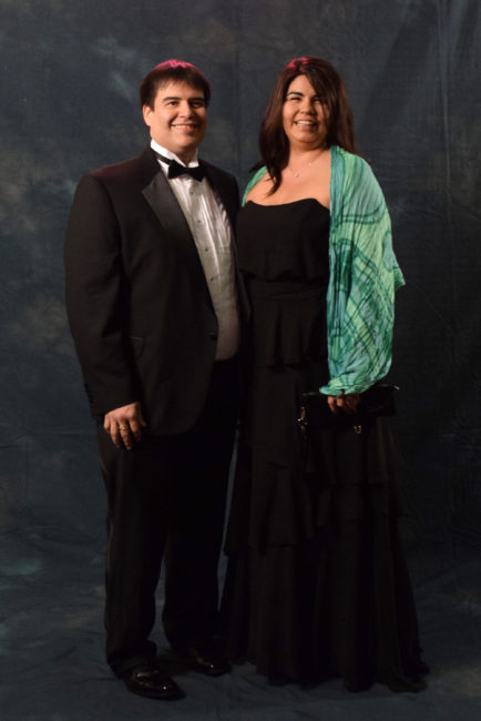Ken Southerland and Katie Pittman. Pittman spent Saturday afternoon shopping and decided on an Alfred Angelo dress from Formals Express. The scarf is from Jineit. Southerland, in a Stafford tux, said, "It feels good once in a while to get dressed up and be adults." (Photo by Skip Gray/KTOO)