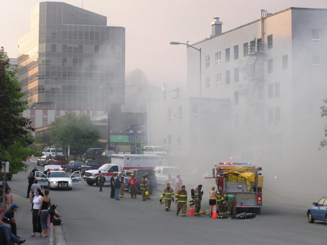 Smoke fills the streets of downtown Juneau as the historic Skinner Building burns, Aug. 15, 2004. (Creative Commons photo by Gillfoto)