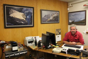 Mitch Falk's office walls are adorned with pictures of goats and wildlife. He enjoys goat hunting when he gets the chance. (Photo by Elizabeth Jenkins/KTOO)
